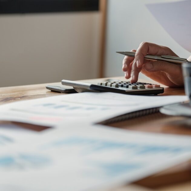 Close up view of bookkeeper or financial inspector hands making report, calculating or checking balance. Close up view of bookkeeper or financial inspector hands making report, calculating or checking balance. Home finances, investment, economy, saving money or insurance concept